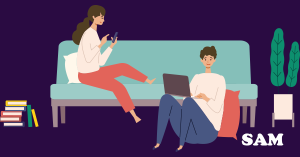 An unmarried couple sitting in a house using a laptop to decide if they need to get a cohabitation agreement