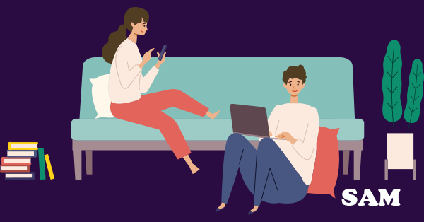 An unmarried couple sitting in a house using a laptop to decide if they need to get a cohabitation agreement