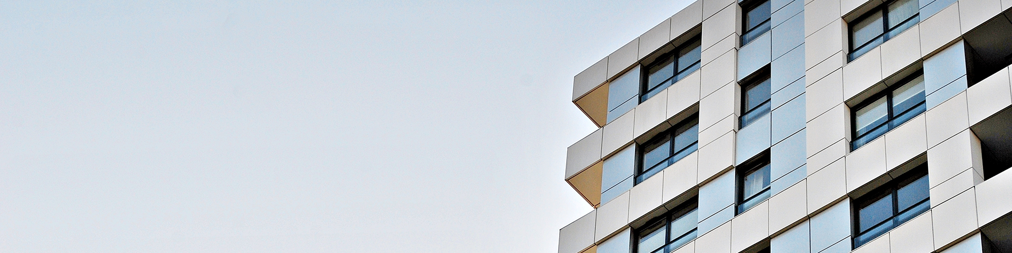 A low angle photo of a block of high rise flats. SAM Conveyancing explain the EWS1 Form: Cladding External Wall System Certificate