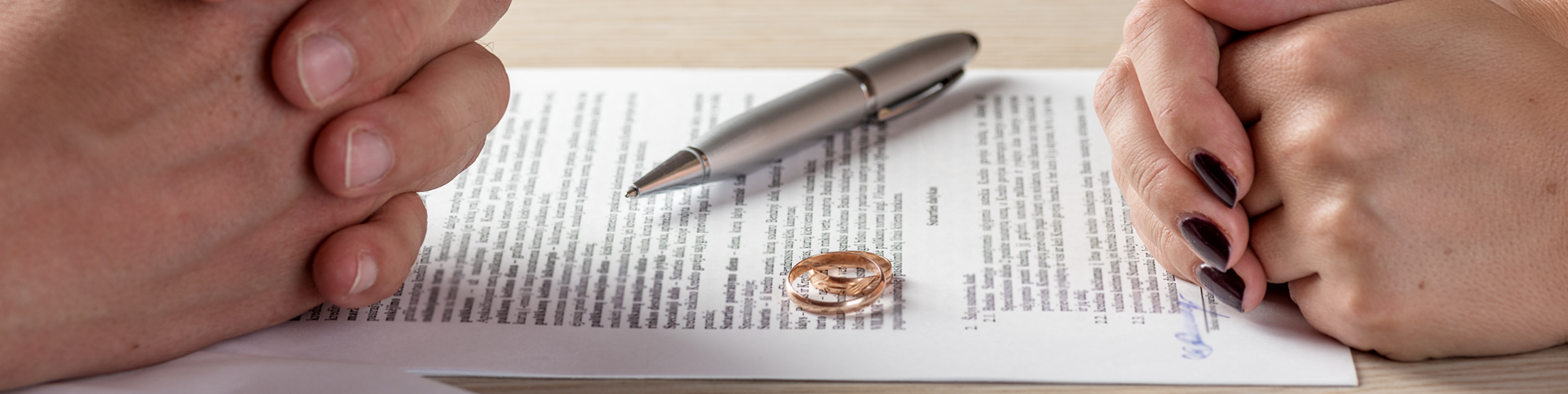 Separated couple with the wedding rings taken off, signing an agreement. SAM Conveyancing's guide to getting occupational rent
