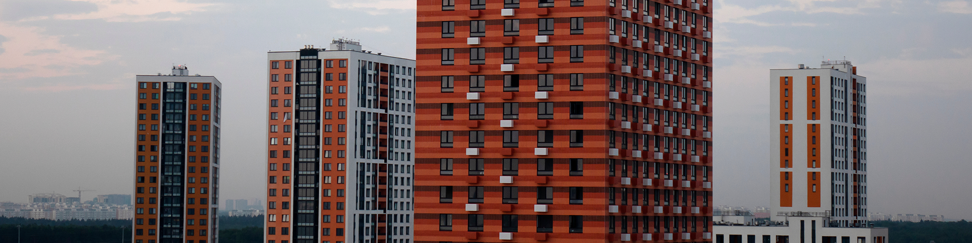 A skyline showing several high rise tower blocks of flats with cladding. Let SAM Conveyancing help if you're selling a flat with cladding