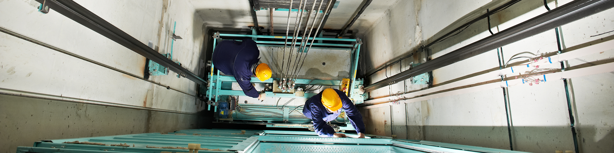 Section 20 Major Works. SAM Conveyancing breaks down leasehold major works payments, otherwise known as 'qualifying works'. Two workers in hard hats and boiler suits are in a lift shaft, repairing the lift.