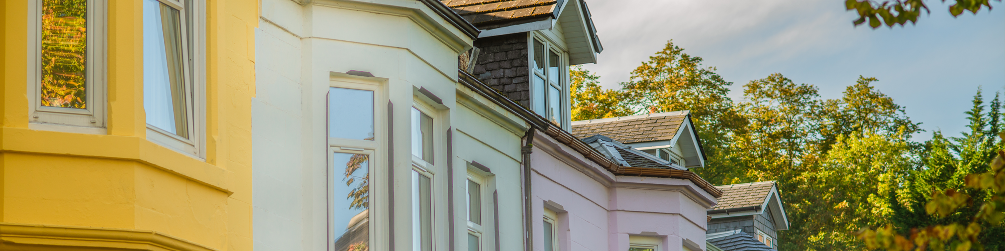 Buy to Let Mortgages with SAM Conveyancing. A sunny Victorian terraced street with bay and dormer windows