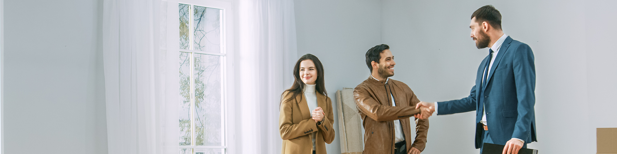 An estate agent shows a young couple around a property viewing. Estate Agents' Legal Obligations to Buyers and Sellers explained by SAM Conveyancing
