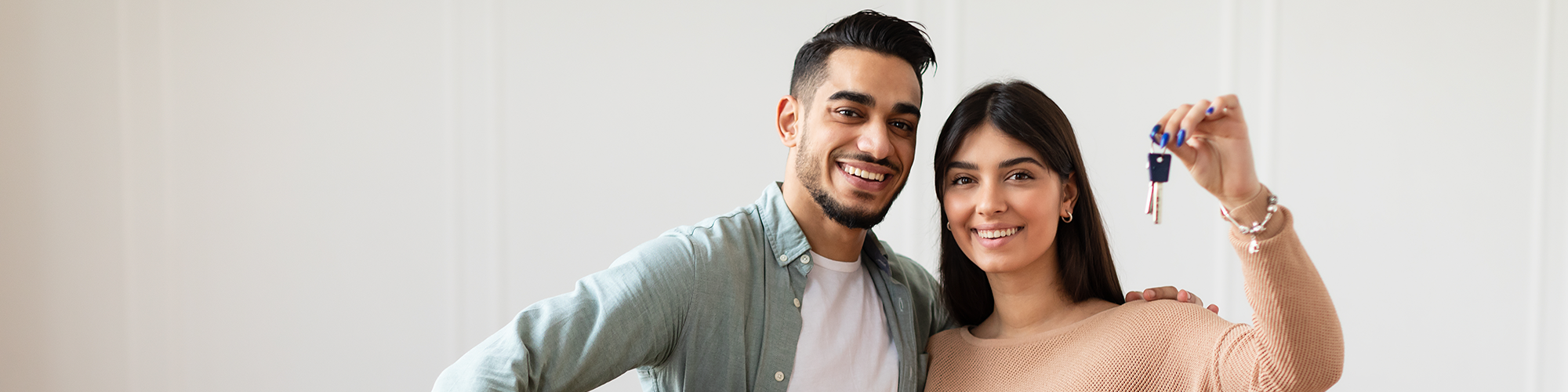 Help to Buy Occupier Consent Independent Legal Advice with SAM Conveyancing. A happy couple pose with their keys as they unpack in their new home.