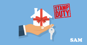 A hand outstretched holding a gifted property and a key hanging off the edge. The words 'Stamp Duty' is stamped in the top right of the image. SAM Conveyancing explains what the stamp duty is on a gifted property A hand outstretched holding a gifted property and a key hanging off the edge. The words 'Stamp Duty' is stamped in the top right of the image. SAM Conveyancing explains what the stamp duty is on a gifted property