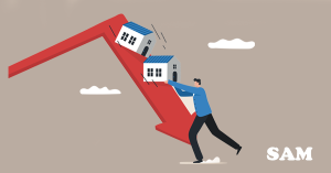 A man holding up two model houses which are sliding down a big red downwards pointing arrow. SAM Conveyancing's guide on 10 things that cause property values to decrease & how to fix them