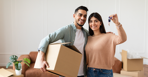 Help to Buy Occupier Consent Independent Legal Advice with SAM Conveyancing A happy couple pose with their keys as they unpack in their new home.