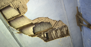 A partially collapsed ceiling revealing traditional lath and wattle under the plaster. SAM Conveyancing describe how to detect potential problems and prevent Lath and Plaster Ceiling Collapse