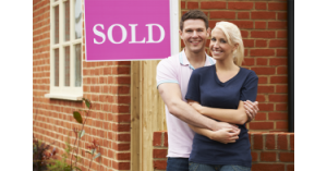 A couple stand in front of their new house. What is Conveyancing? Can you do your own conveyancing? Answered by SAM Conveyancing