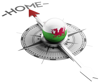 A compass with a Welsh flag pointing at home depicting the Help to Buy Wales home scheme