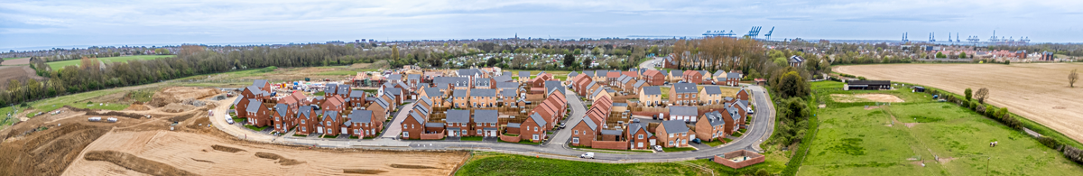 An aerial panoramic view of a new UK housing development and construction groundworks, reflecting new build housing supply in August 2026