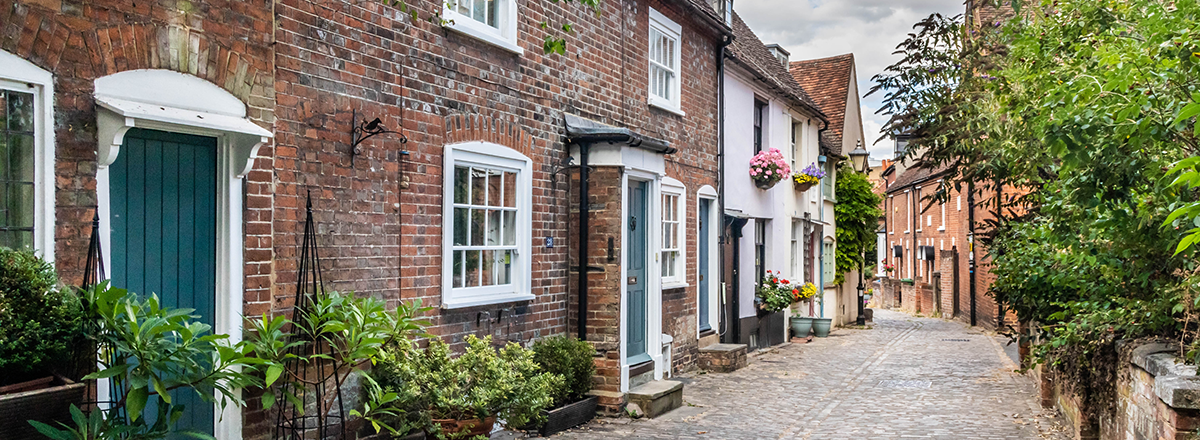 A cobbled terrace of brick cottages in St Mary's Square, Aylesbury, Buckinghamshire, England. SAM Conveyancing's analysis of the Buckinghamshire housing market