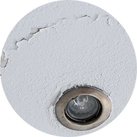 A damaged ceiling showing flaking around a spotlight fitting, flagged in a RICS Home Survey from SAM Conveyancing