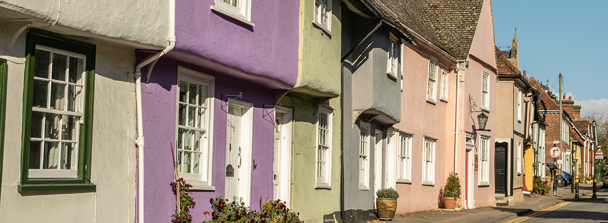 A row of colourful old cottages in Saffron Walden in Essex. SAM Conveyancing's report on the Essex property market