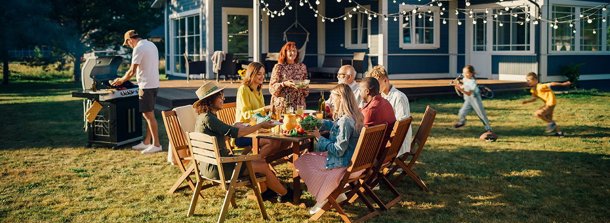 A family celebrate their first summer in their new home. SAM Conveyancing's housing market report on July's boom in activity.