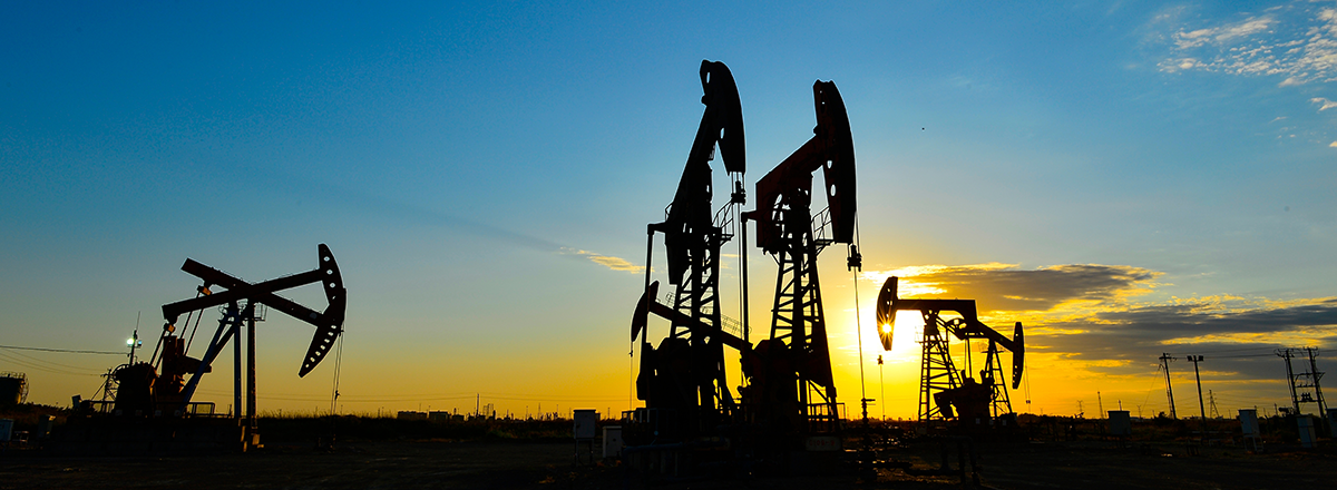 Oil pumps working at sunset, reflecting the impact of oil supply from the middle east on the UK economy and housing market.