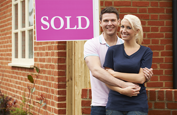 Searches when buying a house are so important to put your mind at ease when you move in - picture of 2 people smiling after they've moved in as illustration