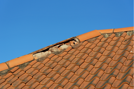 A roof with damaged tiles
