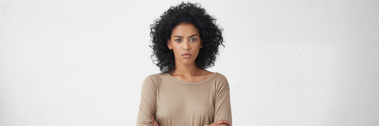 How to Sell a House When One Partner Refuses from SAM Conveyancing: A woman with a stern expression looks directly into the camera with her arms folded